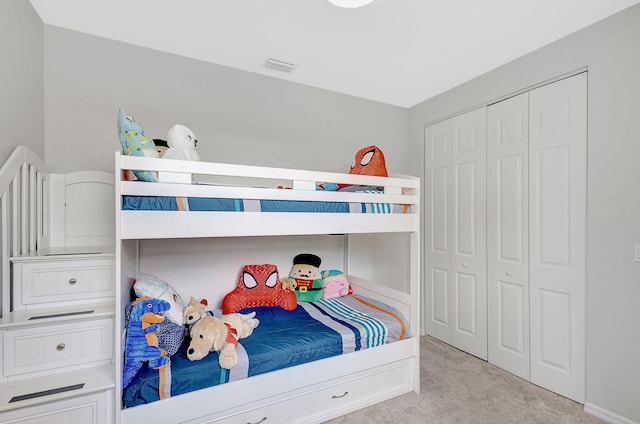 bedroom with a closet and light colored carpet