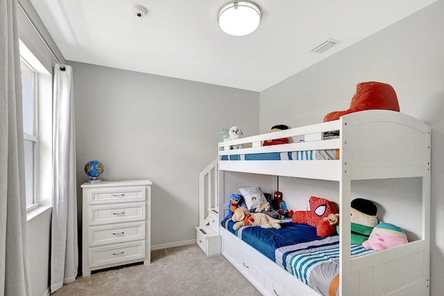 bedroom featuring light colored carpet, visible vents, and baseboards