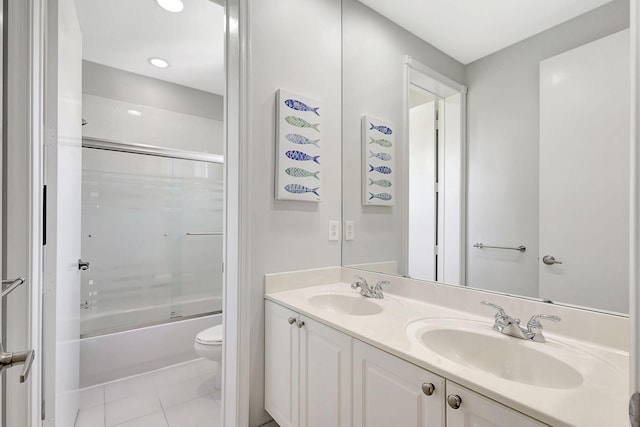 full bathroom with combined bath / shower with glass door, vanity, toilet, and tile patterned flooring