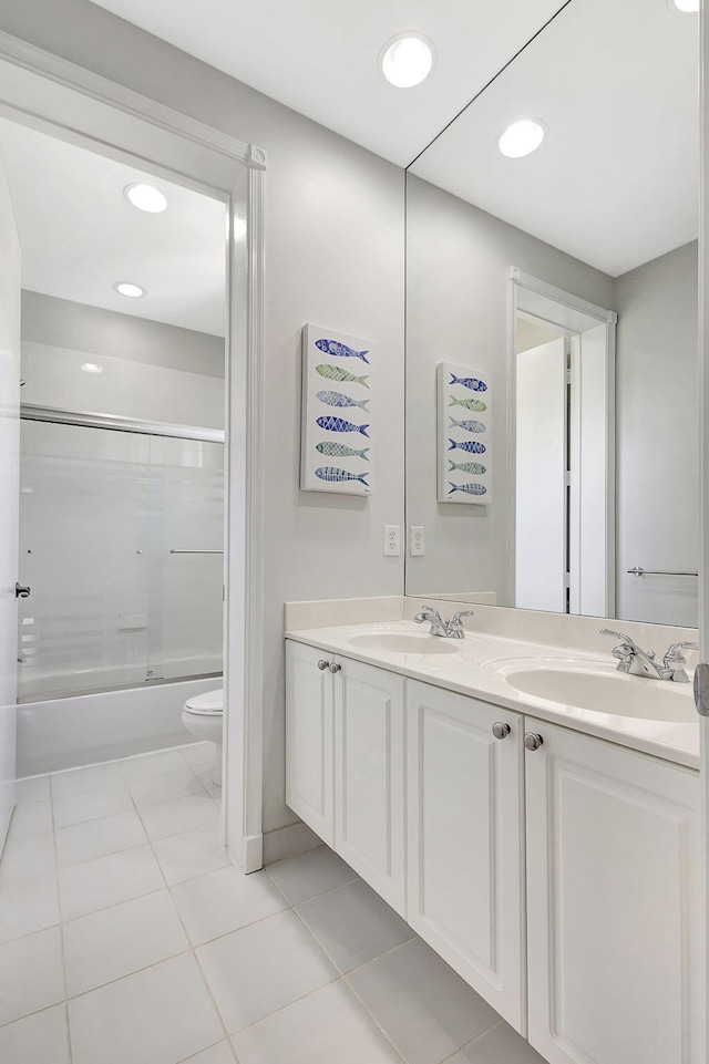 full bathroom with enclosed tub / shower combo, vanity, toilet, and tile patterned floors