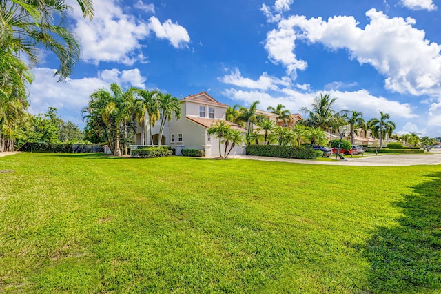 view of yard featuring driveway and a garage