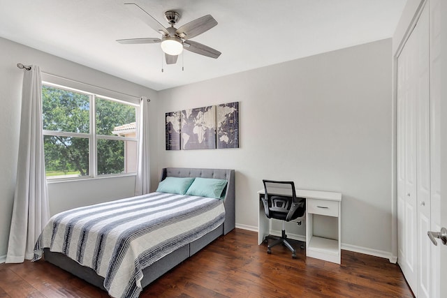 bedroom with ceiling fan, a closet, hardwood / wood-style flooring, and baseboards