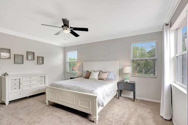 carpeted bedroom featuring multiple windows, ornamental molding, and ceiling fan