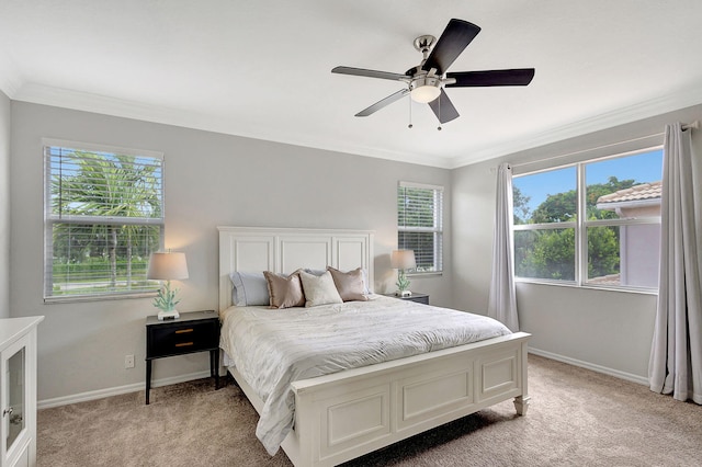 bedroom featuring light carpet, multiple windows, and baseboards