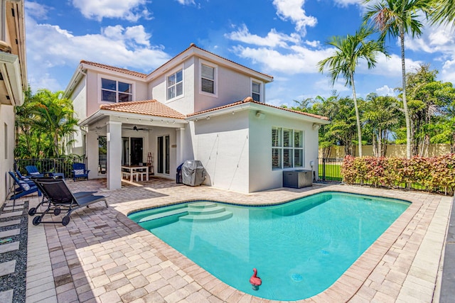 view of swimming pool with a patio and ceiling fan