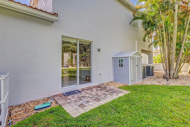 property entrance with a tile roof, a patio area, a yard, and stucco siding