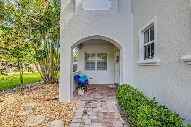 view of exterior entry with stucco siding