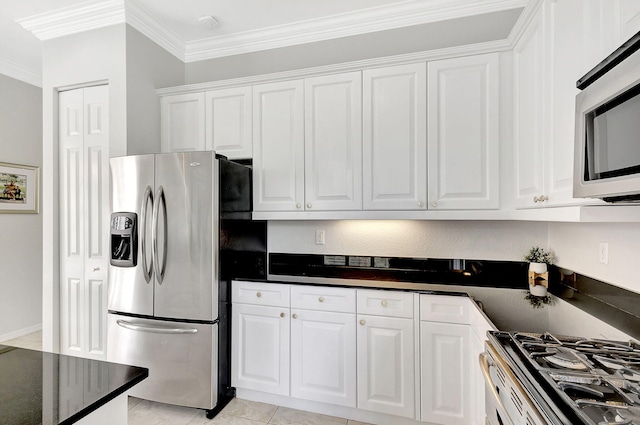 kitchen featuring ornamental molding, white cabinetry, appliances with stainless steel finishes, and light tile patterned floors