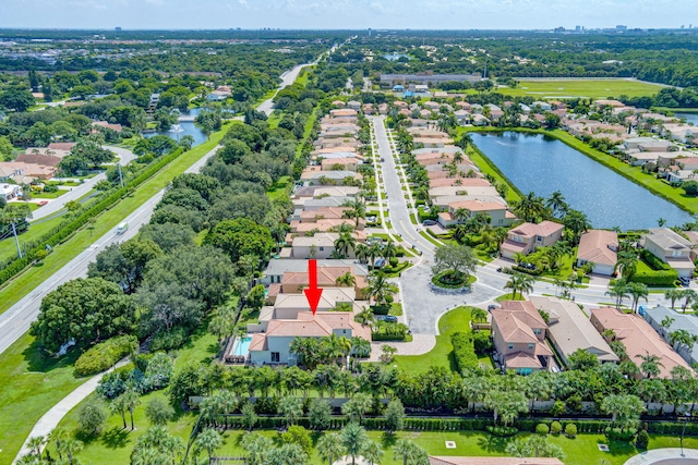 birds eye view of property with a water view and a residential view