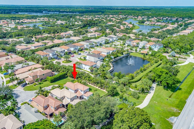 drone / aerial view featuring a water view and a residential view