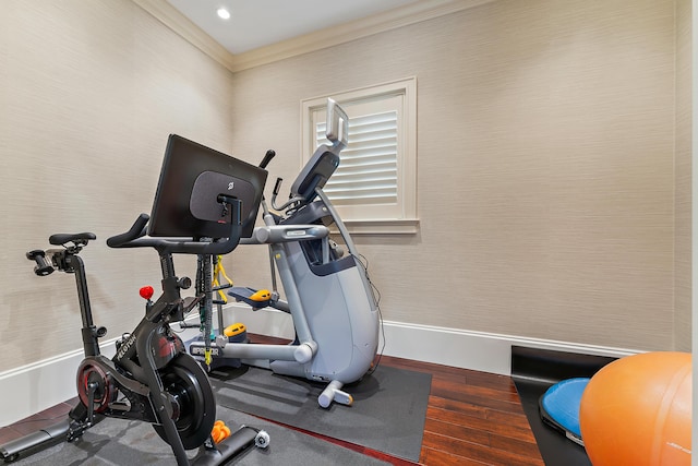 exercise area featuring wood-type flooring and ornamental molding