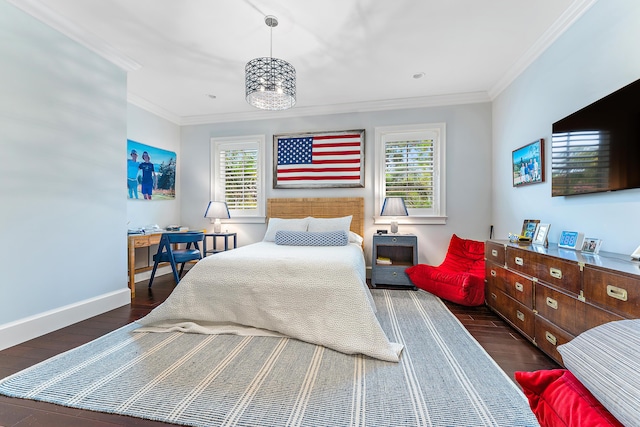 bedroom with dark hardwood / wood-style flooring, crown molding, and a chandelier