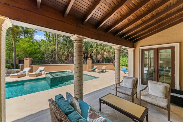 view of swimming pool with a patio area, an in ground hot tub, french doors, and an outdoor living space