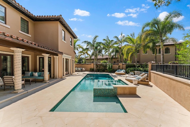 view of pool featuring an in ground hot tub, a patio, and an outdoor hangout area