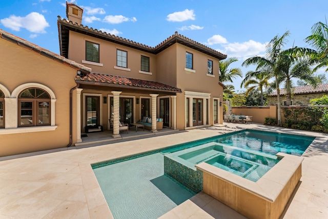 view of swimming pool with a patio area and an in ground hot tub