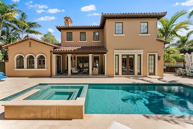 back of property featuring ceiling fan, french doors, a patio, and a pool with hot tub