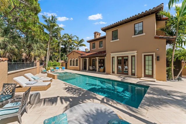 view of swimming pool with an in ground hot tub, french doors, and a patio area