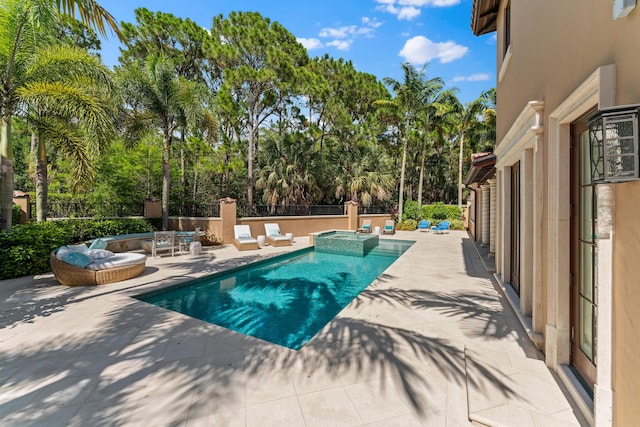 view of pool featuring an in ground hot tub and a patio