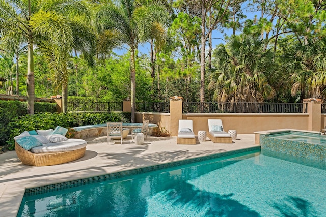 view of pool with an in ground hot tub and a patio