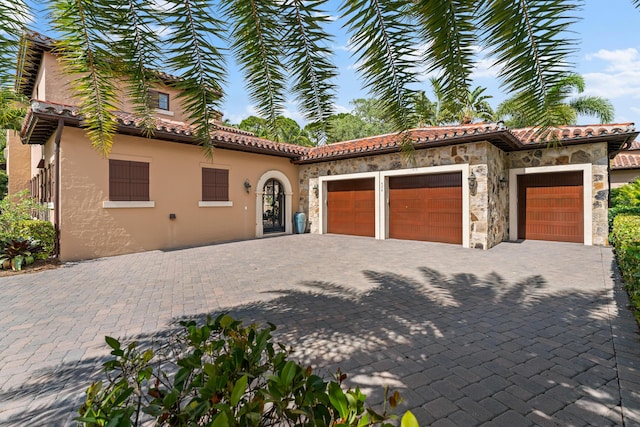 mediterranean / spanish-style home featuring a garage