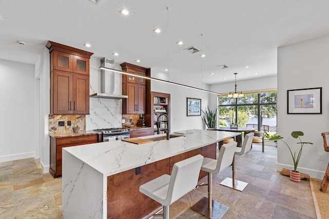 6787 Bayshore Dr, Lake Worth, FL 33462 - kitchen featuring wall chimney exhaust hood, stone tile flooring, baseboards, tasteful backsplash, and recessed lighting