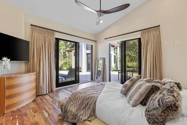 bedroom featuring lofted ceiling, multiple windows, wood-type flooring, and access to outside