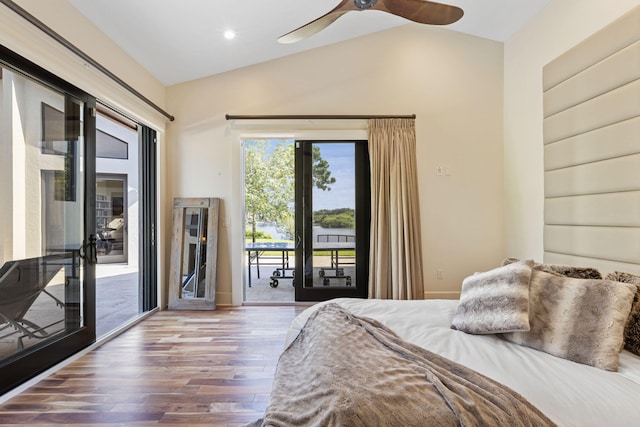 bedroom featuring vaulted ceiling, access to outside, hardwood / wood-style floors, and ceiling fan