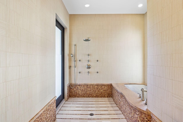 6787 Bayshore Dr, Lake Worth, FL 33462 - bathroom featuring tile walls, a walk in shower, a bath, tile patterned floors, and recessed lighting
