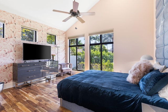 bedroom featuring ceiling fan, hardwood / wood-style floors, and high vaulted ceiling