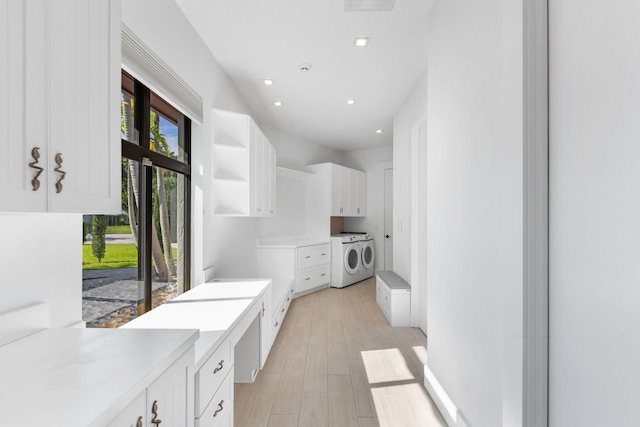 washroom with light hardwood / wood-style flooring and cabinets