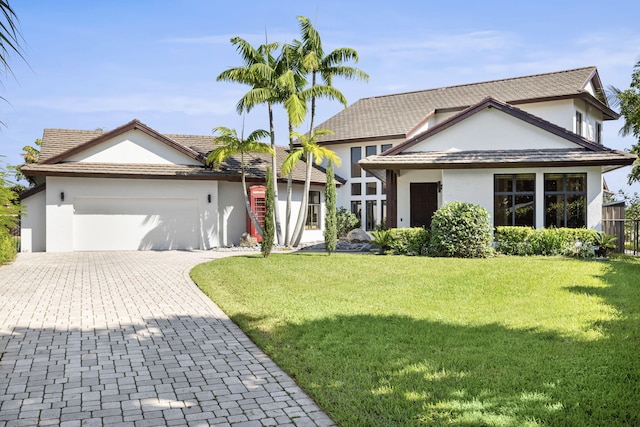 view of front facade with a garage and a front lawn