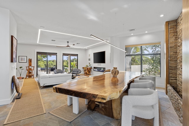 6787 Bayshore Dr, Lake Worth, FL 33462 - dining area featuring stone tile floors, plenty of natural light, recessed lighting, and baseboards