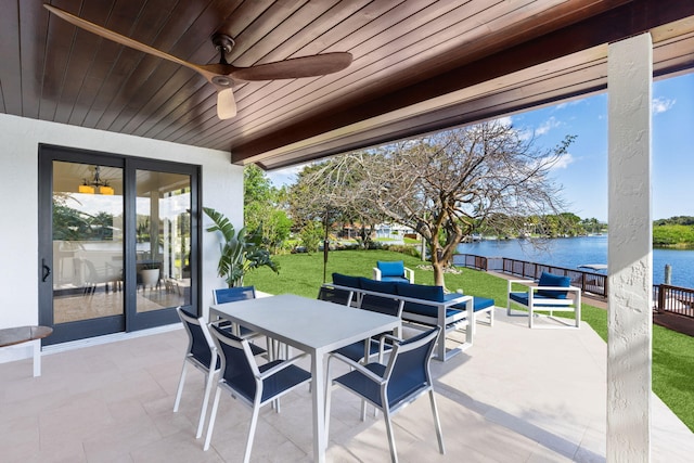 view of patio / terrace with a water view, outdoor lounge area, and ceiling fan