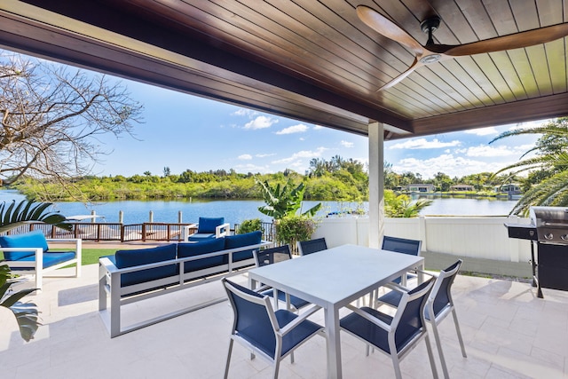 view of patio / terrace featuring a water view, an outdoor living space, area for grilling, and ceiling fan