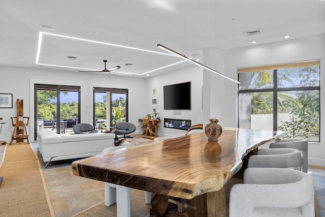 dining area with light tile patterned flooring and ceiling fan