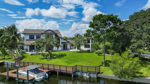 dock area with a patio area, a yard, and a water view