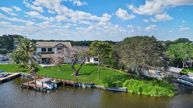 6787 Bayshore Dr, Lake Worth, FL 33462 - dock area with boat lift, a water view, and a lawn