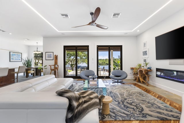 6787 Bayshore Dr, Lake Worth, FL 33462 - living area with baseboards, a ceiling fan, a glass covered fireplace, wood finished floors, and recessed lighting