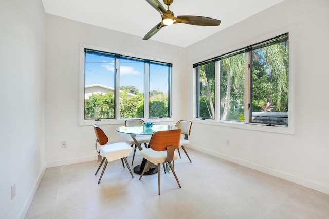 dining space with ceiling fan and light tile patterned floors