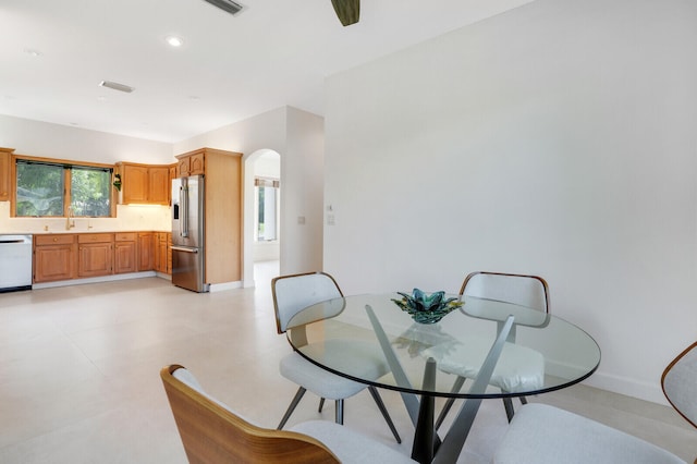 dining space featuring light tile patterned floors and sink