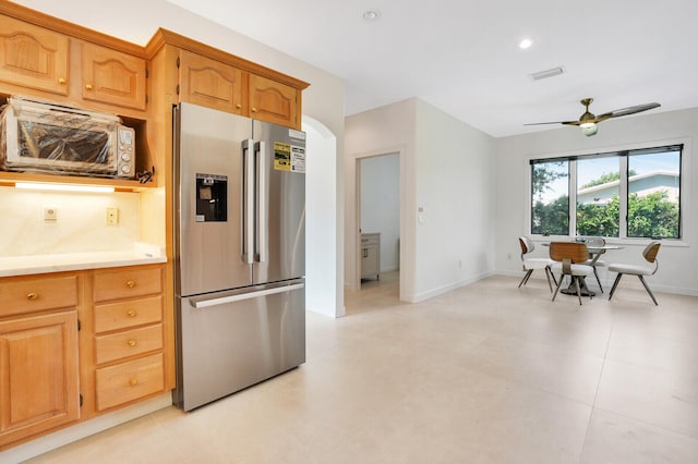 kitchen featuring ceiling fan, stainless steel fridge, and light tile patterned floors