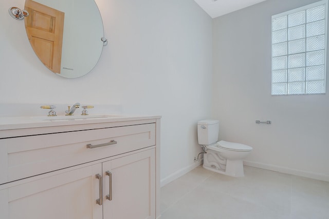 bathroom featuring tile patterned floors, plenty of natural light, vanity, and toilet