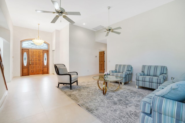 living room with ceiling fan, a towering ceiling, and tile patterned flooring