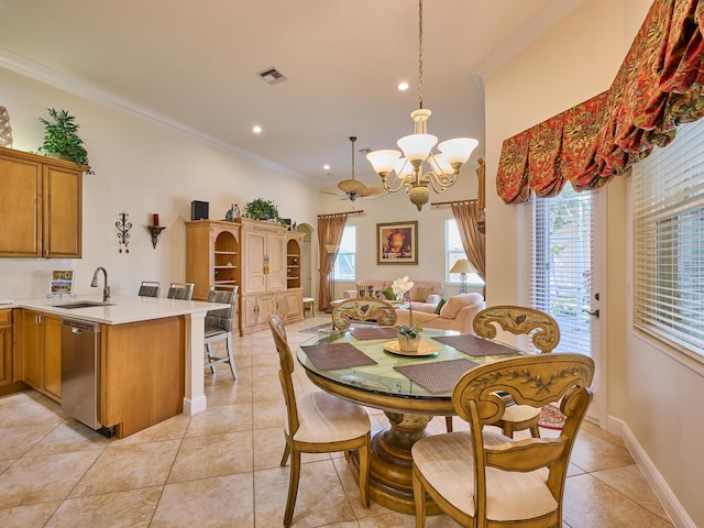 tiled dining space featuring crown molding, sink, and a chandelier