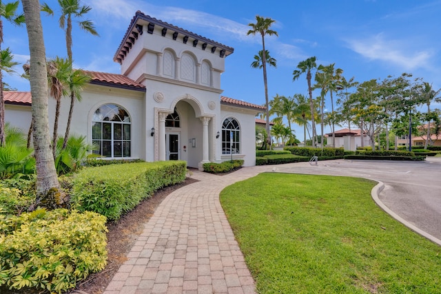 mediterranean / spanish-style house with a front lawn