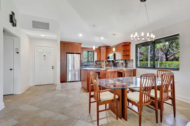 dining room featuring light tile patterned floors, a notable chandelier, and a healthy amount of sunlight