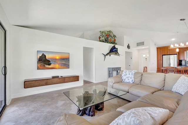 living room with vaulted ceiling, a chandelier, and light tile patterned floors