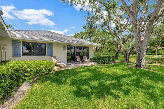 back of property with a patio area and a yard