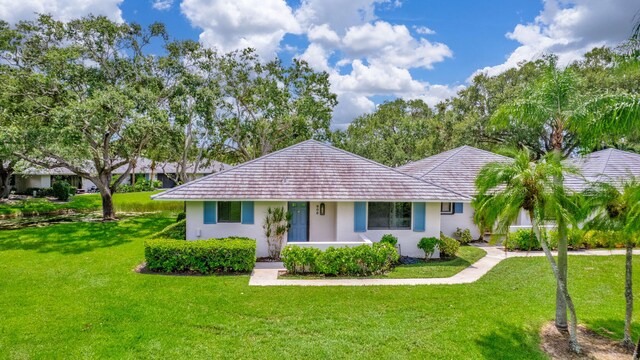 ranch-style home with a front lawn