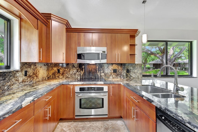 kitchen featuring appliances with stainless steel finishes, a sink, dark stone countertops, and open shelves